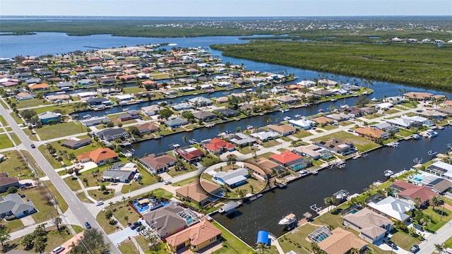 birds eye view of property with a residential view and a water view