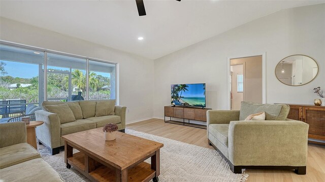 living room with lofted ceiling, light wood-style flooring, a ceiling fan, and recessed lighting