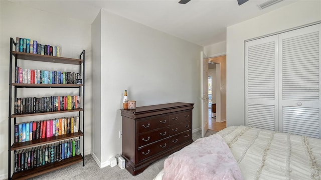 carpeted bedroom with ceiling fan, a closet, visible vents, and baseboards