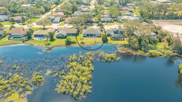 drone / aerial view with a water view and a residential view