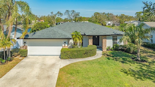 ranch-style home with driveway, a front lawn, roof with shingles, and an attached garage