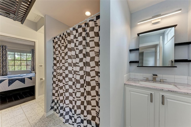 full bathroom featuring a shower with shower curtain, tile patterned flooring, vanity, and connected bathroom