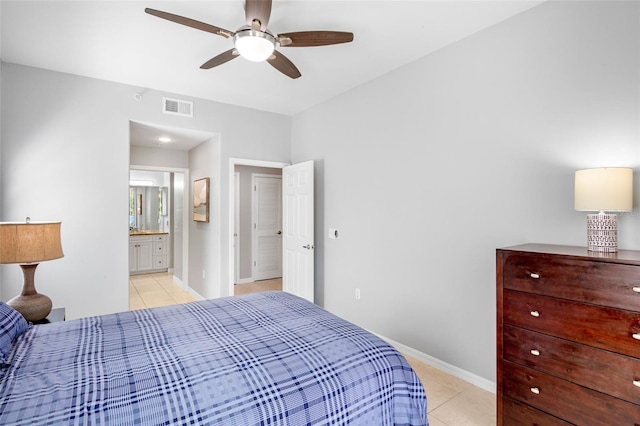 bedroom with visible vents, baseboards, ensuite bathroom, light tile patterned flooring, and a ceiling fan