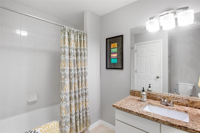 bathroom featuring shower / bath combination with curtain, toilet, vanity, and baseboards