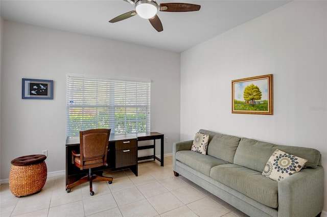 office area with light tile patterned floors, baseboards, and ceiling fan