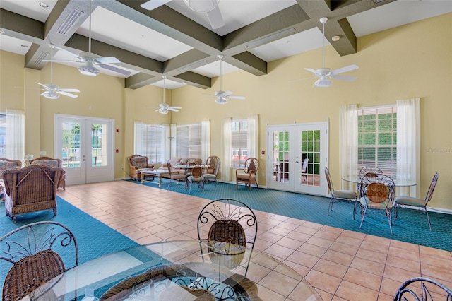 interior space with french doors, coffered ceiling, and beamed ceiling