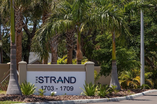 community sign featuring fence