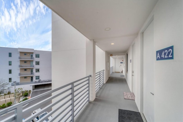 corridor with finished concrete flooring and recessed lighting