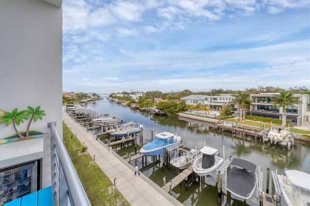 balcony featuring a water view, boat lift, and a dock