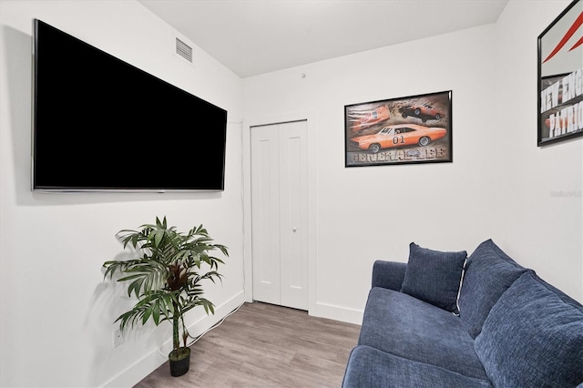 living room featuring wood finished floors and baseboards