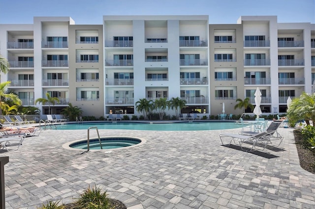 community pool featuring a patio and a community hot tub