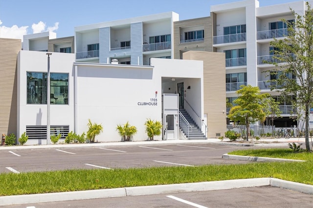 view of building exterior featuring uncovered parking