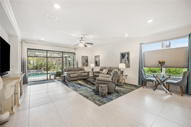 living room featuring visible vents, a wealth of natural light, light tile patterned floors, and a sunroom