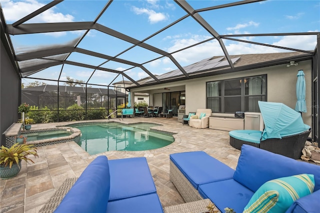 view of swimming pool featuring a lanai, a pool with connected hot tub, an outdoor hangout area, and a patio