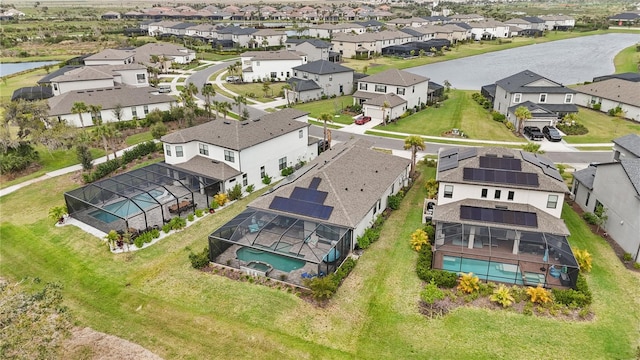 birds eye view of property featuring a water view and a residential view