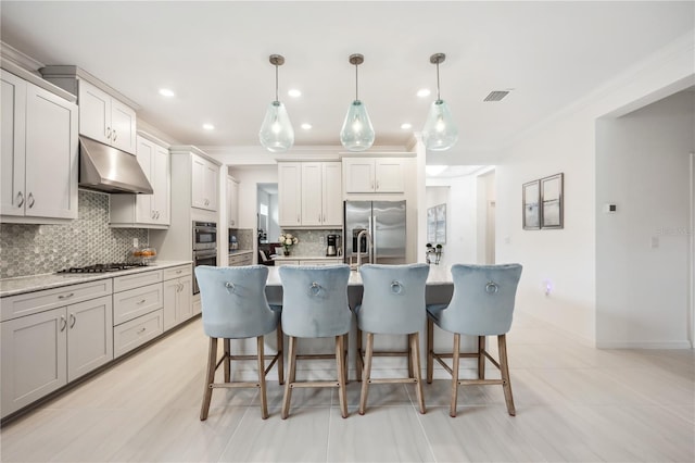 10179 Milky Way Cir, Sarasota, FL 34241 - kitchen with a kitchen breakfast bar, visible vents, tasteful backsplash, under cabinet range hood, and stainless steel appliances