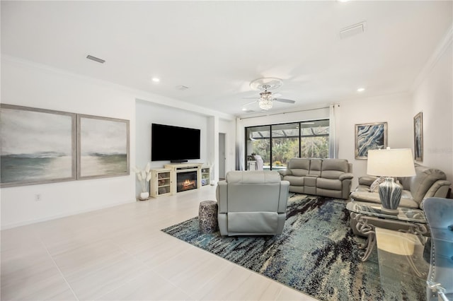 10179 Milky Way Cir, Sarasota, FL 34241 - living room featuring crown molding, a ceiling fan, a glass covered fireplace, and visible vents