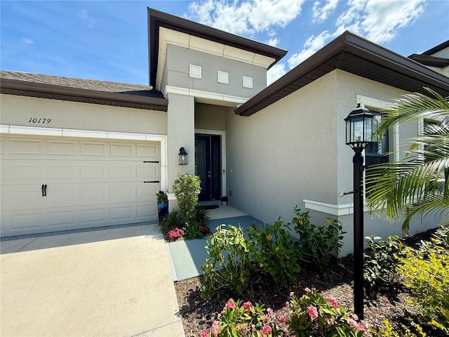 10179 Milky Way Cir, Sarasota, FL 34241 - view of front of house with stucco siding, driveway, and an attached garage