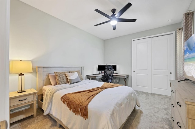 bedroom featuring ceiling fan, a closet, and light colored carpet