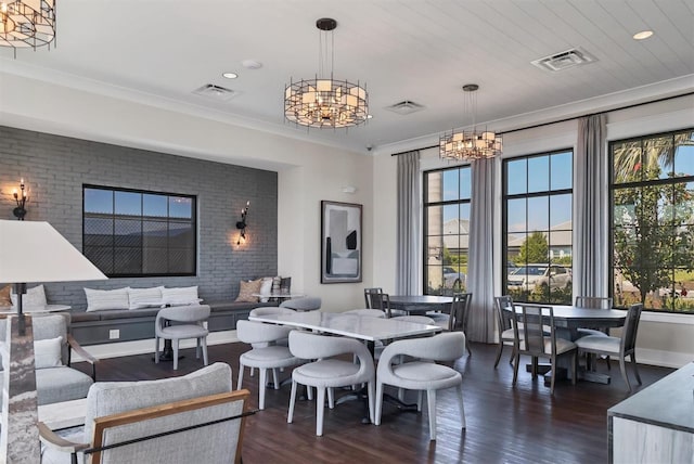 dining area featuring ornamental molding, visible vents, dark wood-type flooring, and an inviting chandelier