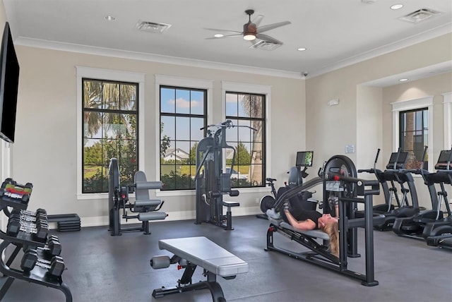 exercise room with ornamental molding, visible vents, and baseboards