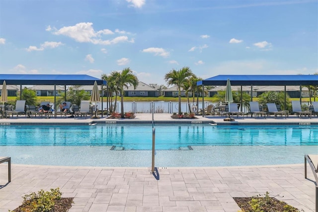 community pool with a patio and fence