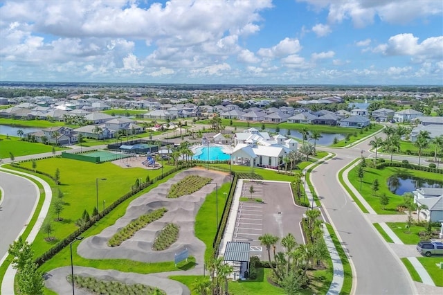 drone / aerial view with a water view and a residential view