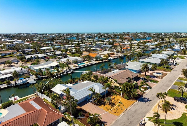 drone / aerial view featuring a residential view and a water view