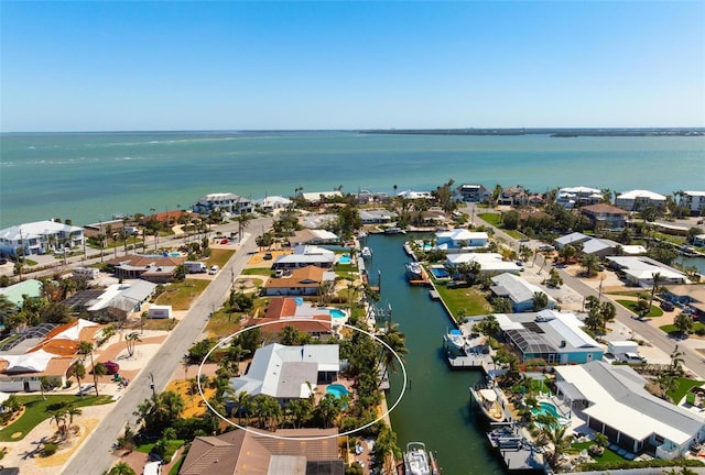 drone / aerial view with a residential view and a water view