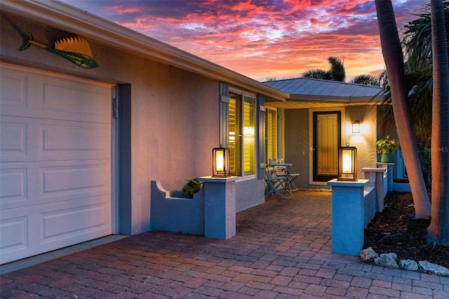 view of patio / terrace featuring a garage