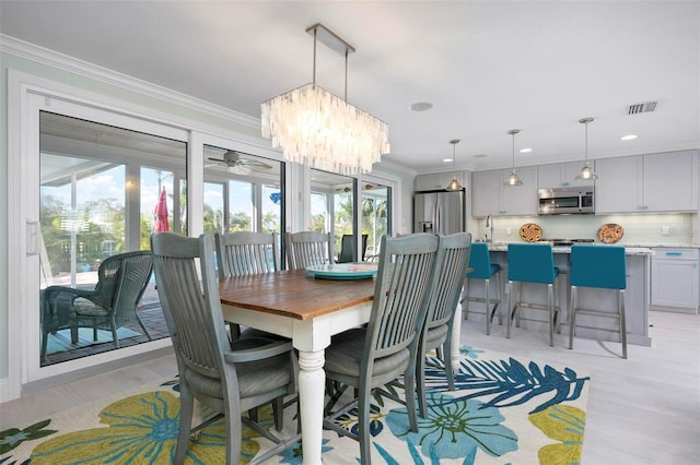 dining room with recessed lighting, visible vents, light wood finished floors, and ornamental molding