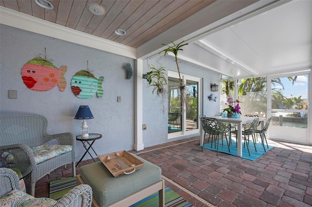 exterior space with lofted ceiling with beams and wooden ceiling