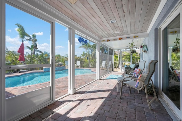 unfurnished sunroom with wood ceiling