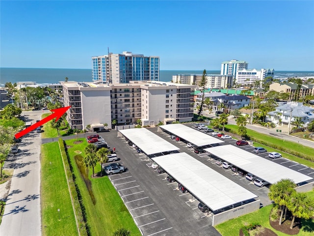 birds eye view of property featuring a city view and a water view