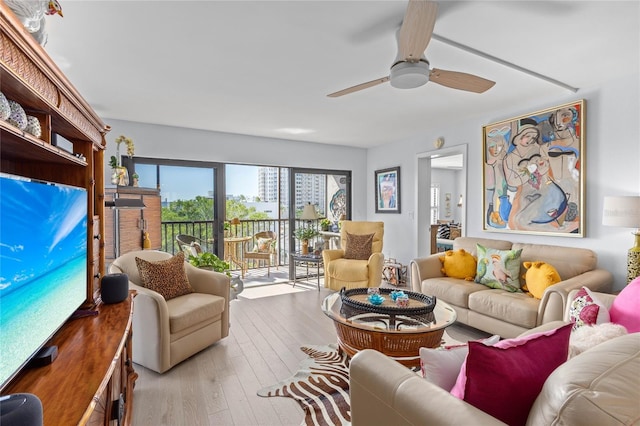 living area featuring ceiling fan and hardwood / wood-style flooring