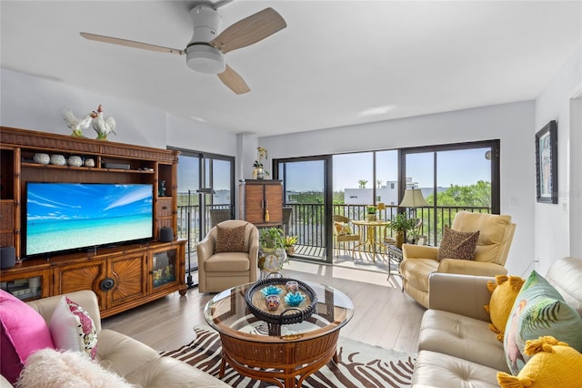 living room with ceiling fan and wood finished floors