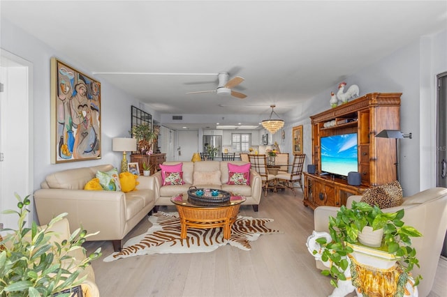 living room with ceiling fan and wood finished floors