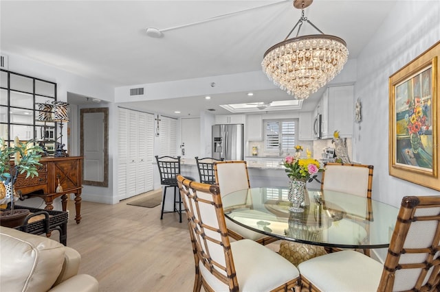 dining area featuring recessed lighting, visible vents, ceiling fan with notable chandelier, and light wood finished floors