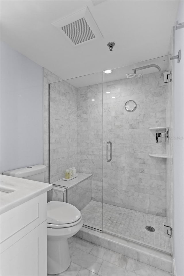 full bath featuring vanity, visible vents, a shower stall, toilet, and marble finish floor