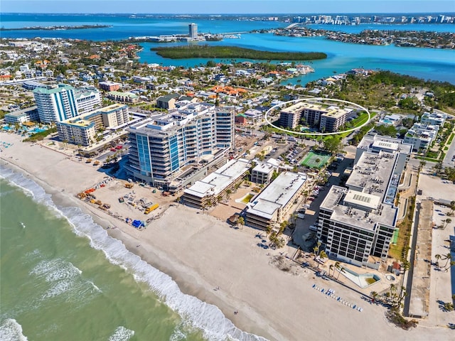 drone / aerial view featuring a beach view, a view of city, and a water view