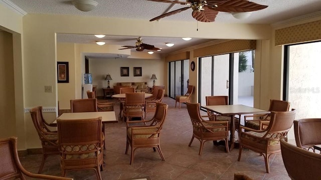 dining room featuring a ceiling fan and a textured ceiling