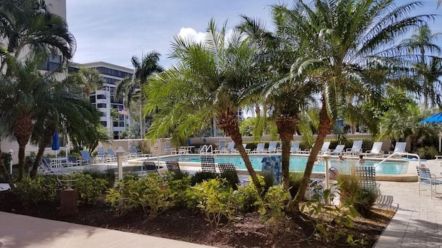 community pool featuring a patio and fence