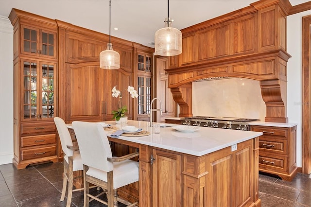 kitchen featuring glass insert cabinets, light countertops, brown cabinets, and a sink