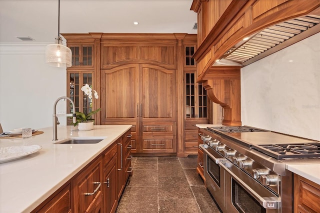 kitchen featuring range with two ovens, custom exhaust hood, light countertops, glass insert cabinets, and a sink