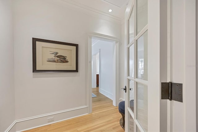 hall with ornamental molding, light wood finished floors, baseboards, and recessed lighting