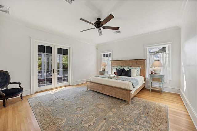 bedroom featuring access to exterior, french doors, visible vents, and crown molding