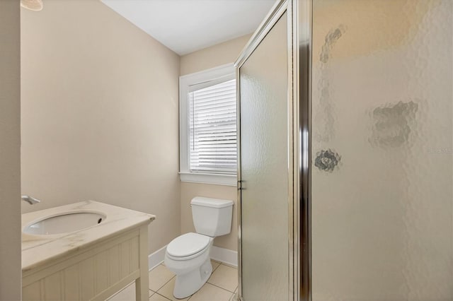 full bath featuring toilet, a stall shower, vanity, tile patterned flooring, and baseboards