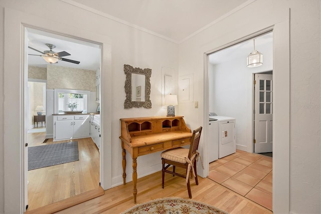 interior space featuring ornamental molding, washer and clothes dryer, and light wood-type flooring