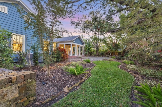 yard at dusk with central AC unit