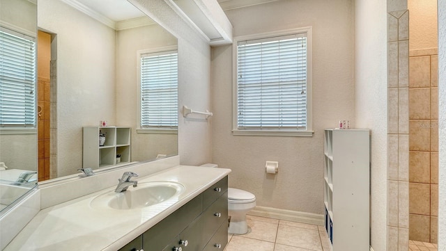 bathroom featuring tile patterned flooring, crown molding, baseboards, toilet, and vanity